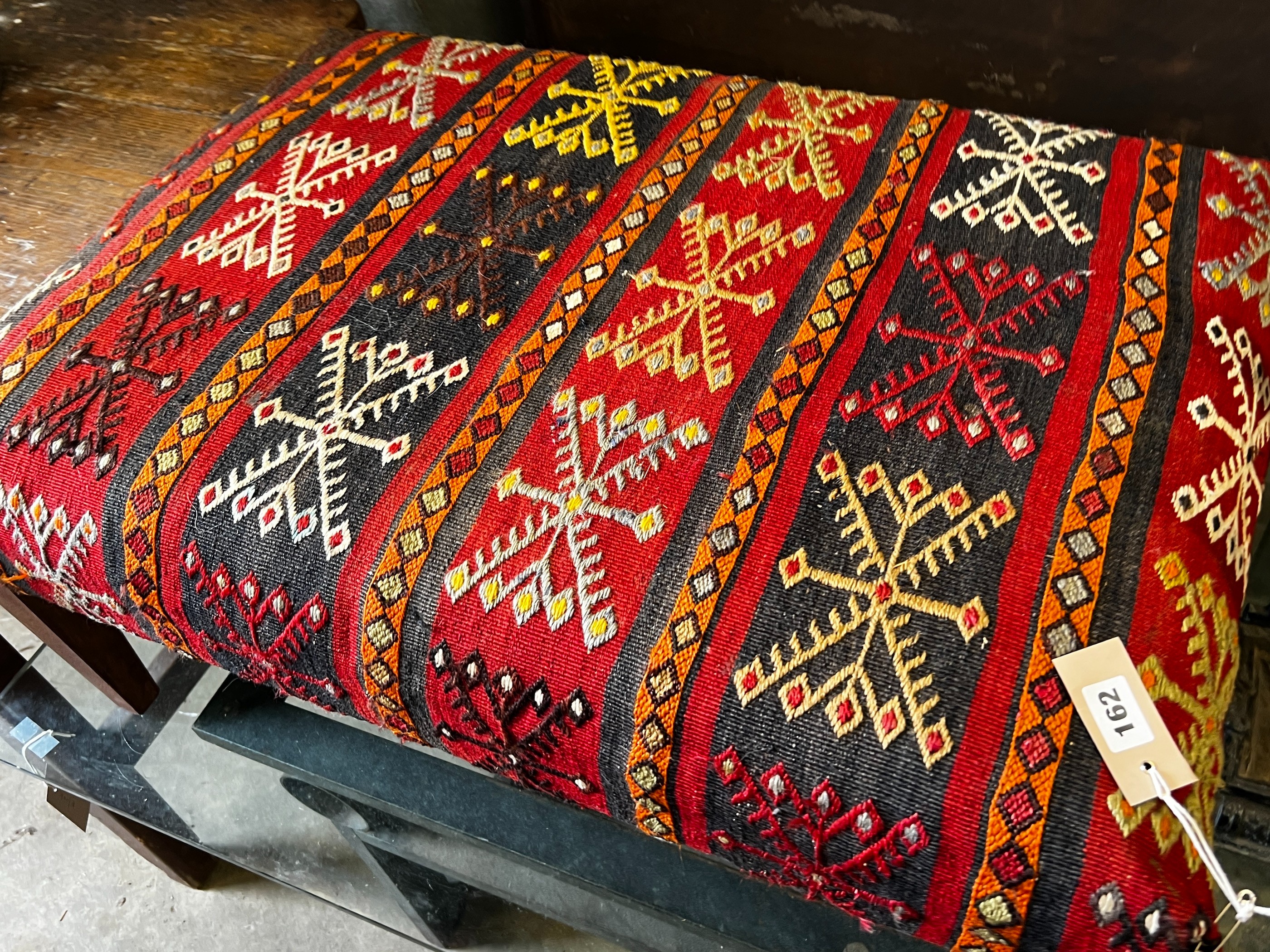 A rectangular Kilim upholstered foot stool, width 82cm, depth 56cm, height 35cm